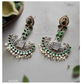 Ornate earrings with green and silver design on a light background